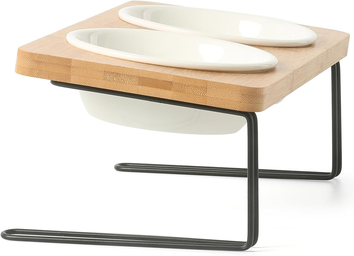 Tilted ceramic double bowl set on bamboo and metal stand