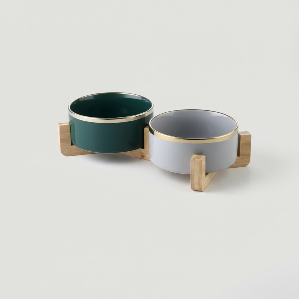 Two-tone forest green and stone grey ceramic double bowl set with gold rim on bamboo stand